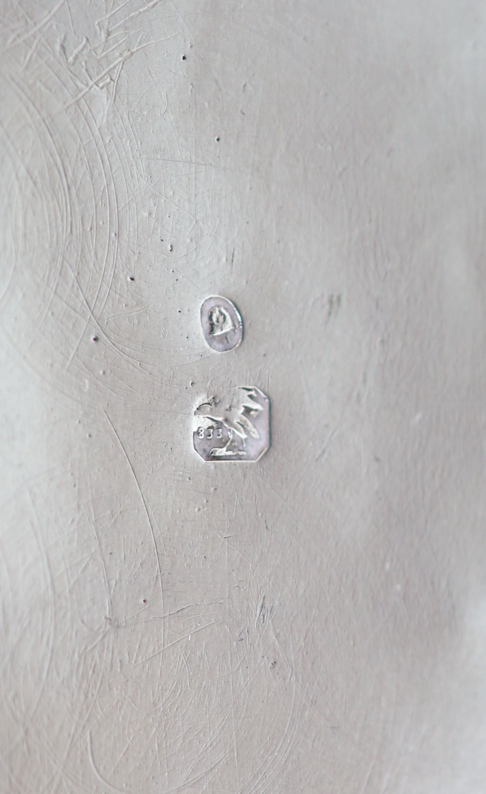 A 20th century Portuguese 833 standard silver rectangular box and cover, the lid cast and chased in high relief with travellers approaching a town,
